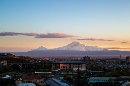 A beautiful sunset view of Yerevan city with the snowy peaks of Mount Ararat in the background