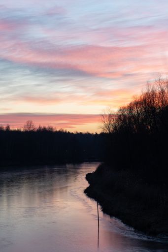 a vertical shot of a river during sunset.