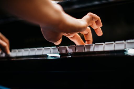 A close-up shot of female hands playing the piano during the concert