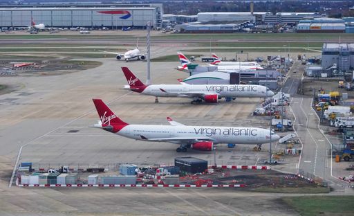 A high angle view of Virgin Atlantic and British Airways aeroplanes on the ground at London Heathrow airport.