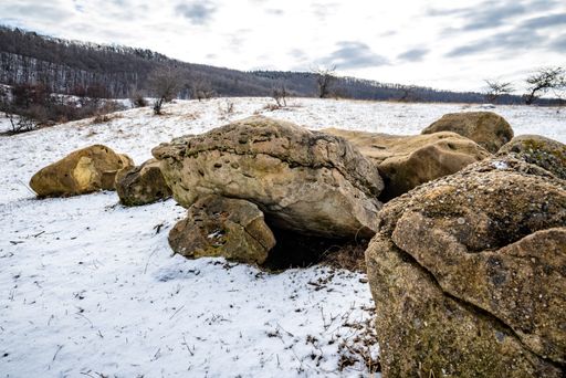 A picturesque view of stones in the field against a background of cloudy skies