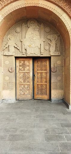 The beautifully ornate wooden doors and wall of  Saint Sarkis Cathedral in Yerevan, Armenia.