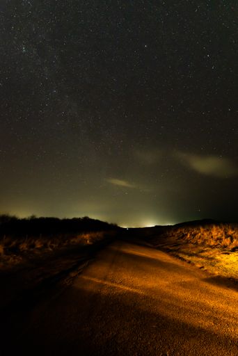 A long road leads to the Druridge bay at night