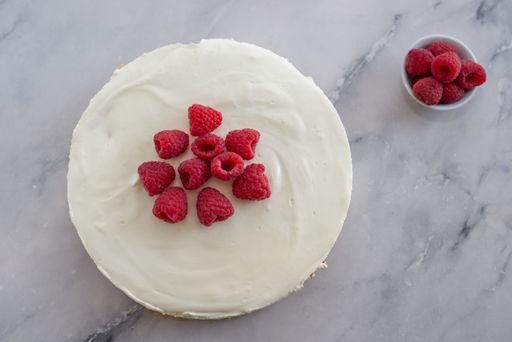 A top view of sweet homemade cheesecake with raspberries
