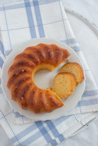 A top view of lemon sponge cake on a white plate