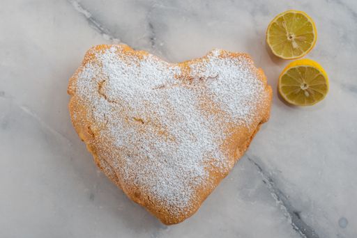 A top view of heart-shaped lemon cake on a table