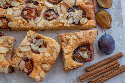 A top view of slices of sweet homemade plum crumble pie on a table