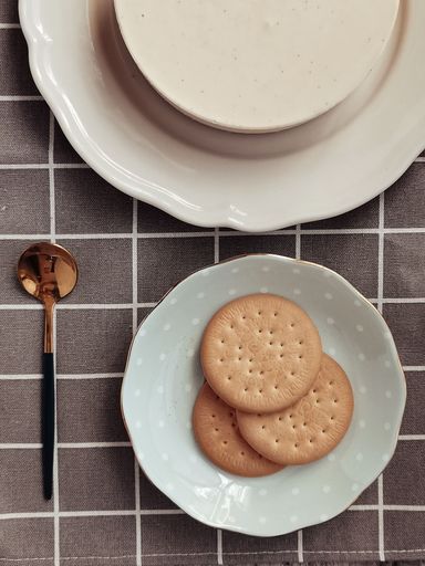 A top view of a delicious homemade cheesecake and cookies on a table
