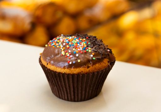 A close-up shot of a freshly baked delicious muffin topped with chocolate