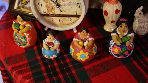 A closeup of wooden colorful figurines on the red table cloth
