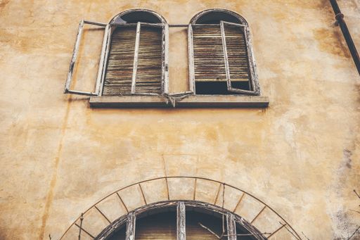 A low angle shot of broken white and brown wooden windows at daytime