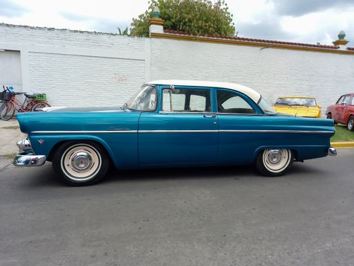 vintage blue Ford Customline V8 two door sedan 1955 - 1956 in the street. Side view. CADEAA 2021 classic car show. Copyspace.