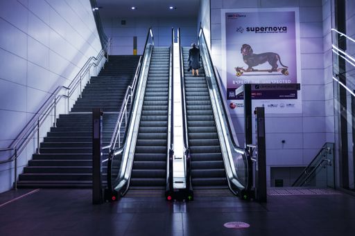 An old woman alone in the metro station
