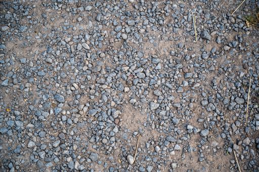 A high angle shot of the ground covered in small stones at daytime