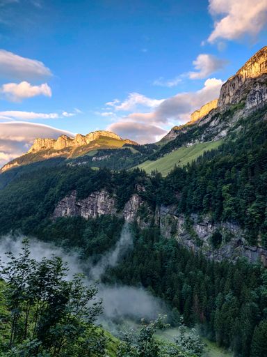 Panoramic view of the Alp Sigel in swiss mountains with fog in the middle of it, Schwende, Switzerland.