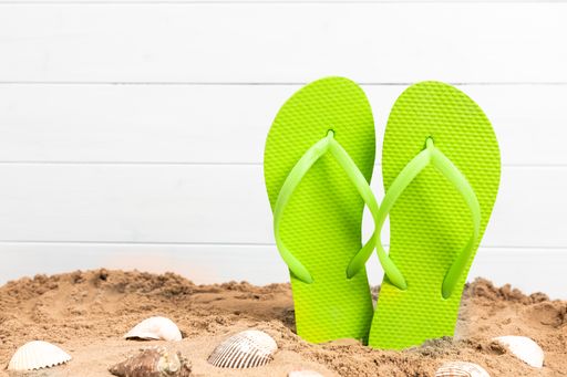 flip flops with shellfish and sand for summetime with copy space