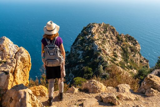 A closeup of a young hiker at the Mirador de Carabineros in the Penon de Ifach Natural Park in Spain