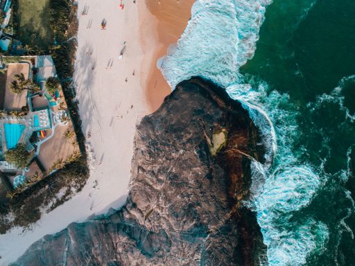 An aerial view of a cliff and the sandy beach in Brazil