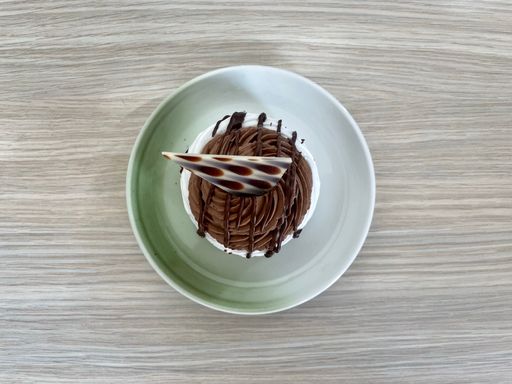 Top view of Meringue-based dessert Pavlova with chocolate cream and chocolate decoration. Cake is named after the Russian ballerina.