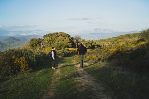 A male and female hikers on the path of the green route through the peak of  La sierra, Andaluza