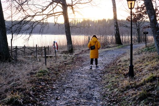 A shot of girl walk down the path along the river