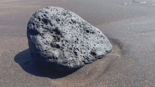 A close-up shot of a big stone on a sand