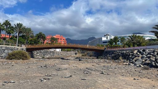 A beautiful view of the bridge under the blue cloudy sky in Costa Adeje, Spai