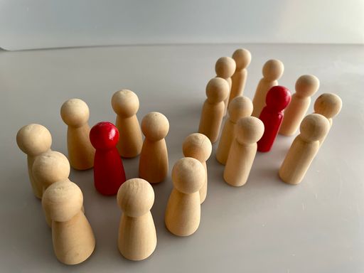 A close-up shot of wooden figures on a grey background