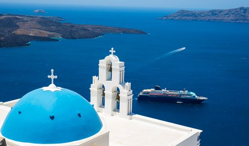 A top view from the church blue dome to a cruise ship and the seascape in Santorini, Greece