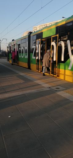A vertical shot of people standing inside a public transport tram at the Stare Zegrze stop
