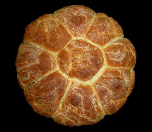 A closeup of a fresh homemade circle bread on black background