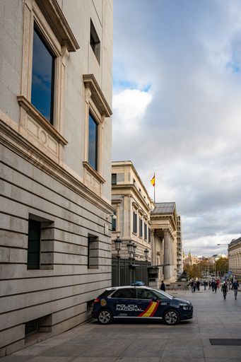 A police Citroen C4 Picasso car parked at the Congress of Deputies in Madrid against cloudy sky