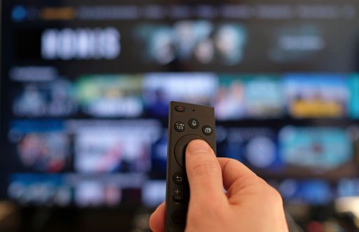 The Remote control and screen - binge-watching the favorite TV show