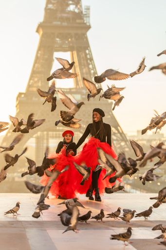 A vertical shot of a Black mother with her daughter in Paris, France