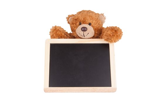A closeup shot of a cute teddy bear with blackboard isolated on white background