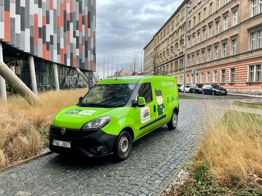Green delivery van of the DoDo transport company parked in Prague in Karlin in front of Main Point Karlin building.