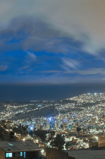 A vertical picture of city lights at night under the beautiful sky