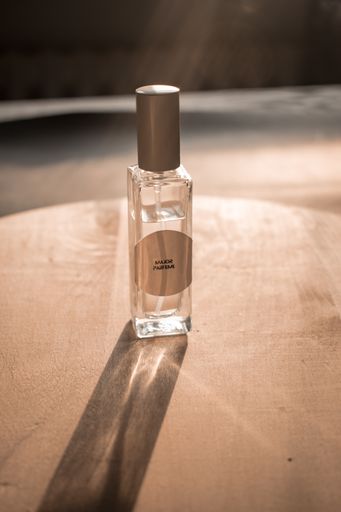 A close-up shot  of perfume bottle  with an aesthetic background