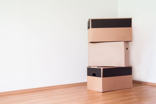 A closeup shot of a stack of cardboard boxes in the corner of the room