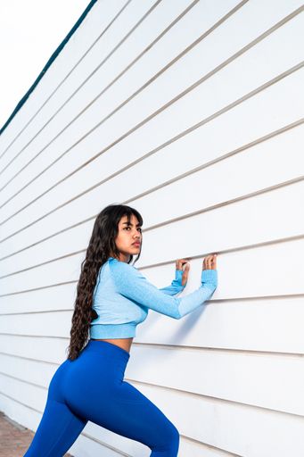 A Attractive Colombian woman dressed in sportswear stretching her muscles after finishing her exercise