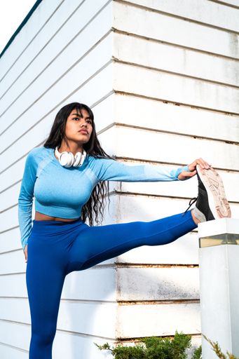 A Attractive Colombian woman dressed in sportswear stretching her muscles after finishing her exercise
