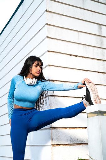 A Attractive Colombian woman dressed in sportswear stretching her muscles after finishing her exercise