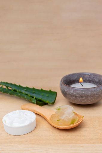 A closeup of Aloe skin care products on a wooden background - Organic skincare concept