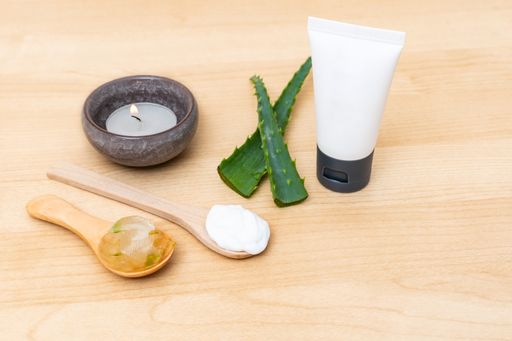 A flat lay composition with aloe vera leaves on wooden background