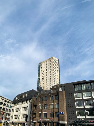 A vertical shot of the apartment building against the blue sky in Eindhoven, Netherlands