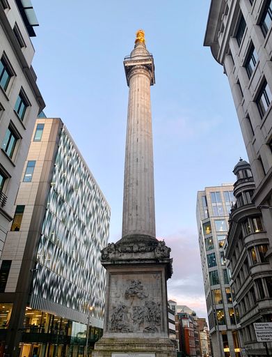A low angle view of the Monument, built to commemorate the Great Fire of London in 1666, in the City of London, UK.
