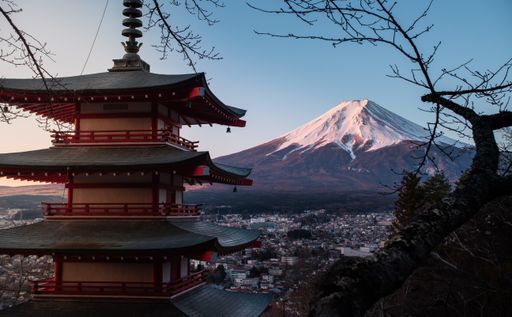 A horizontal shot of the red Chureito Pagoda in Japan, with Fujiyama (Mount Fuji) in the background