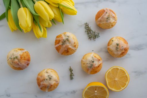 A top view of appetizing lemon muffins with mint and yellow tulips