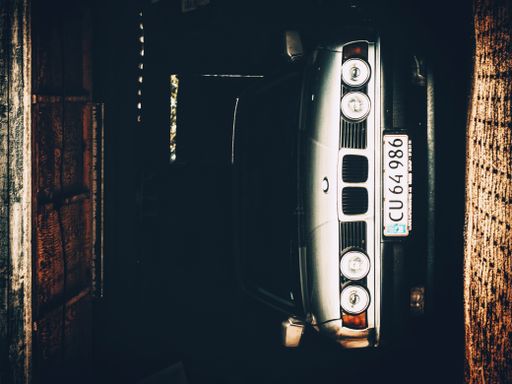 A closeup of a car in the garage for maintenance