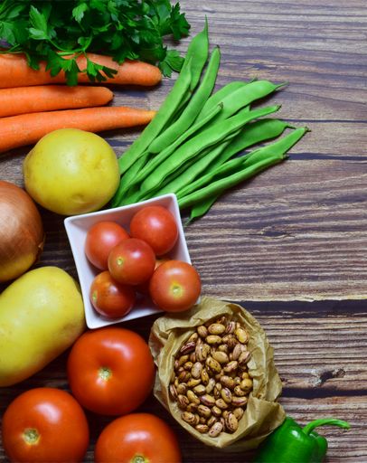 A closeup shot of healthy vegetables on the wooden background